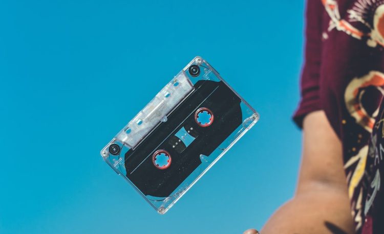 person doing tricks on cassette tape
