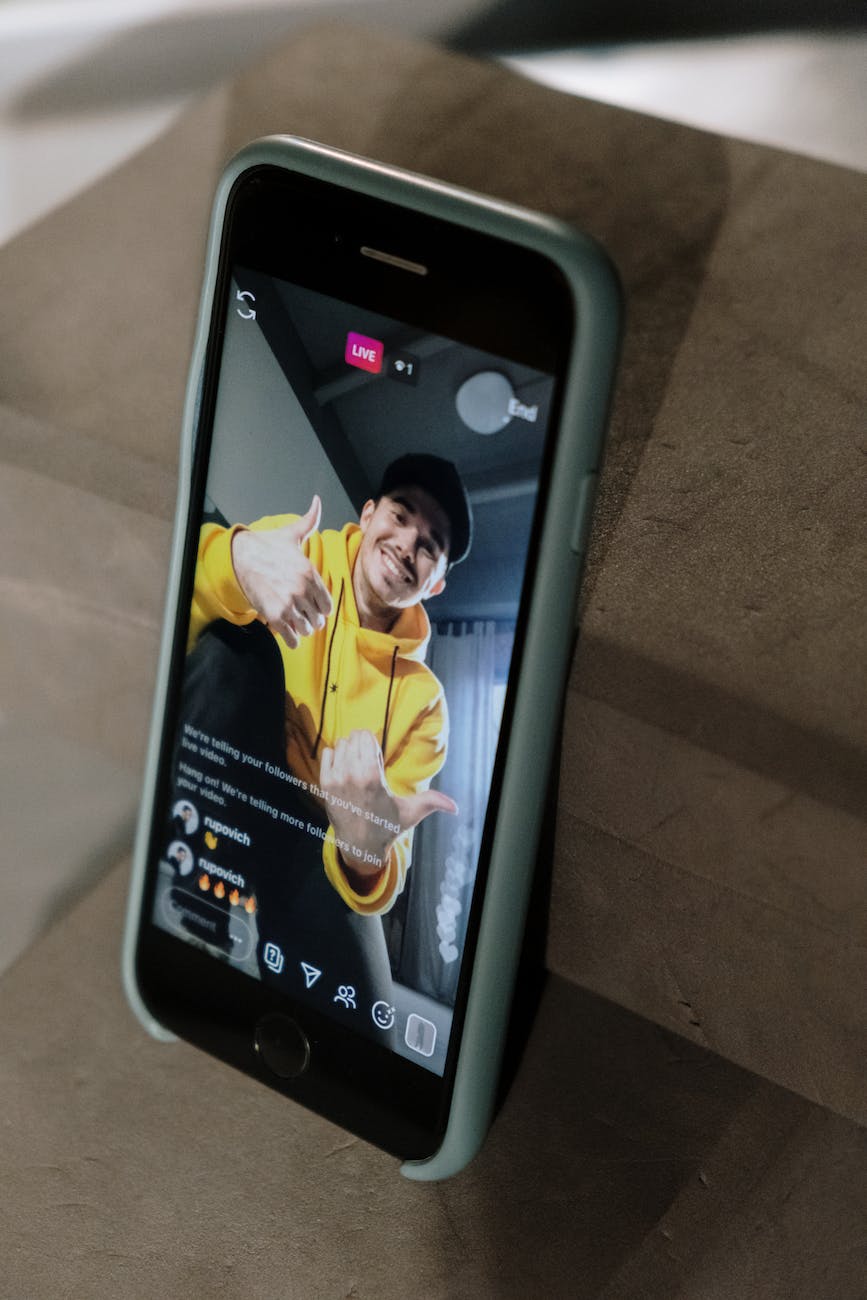 man in yellow hoodie sweater doing live in social media