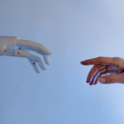 person reaching out to a robot