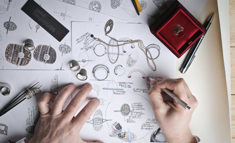 jewelry designer designs jewelries on paper