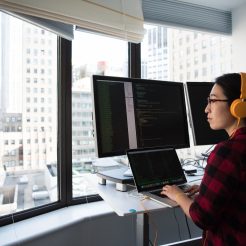 woman sitting while operating macbook pro