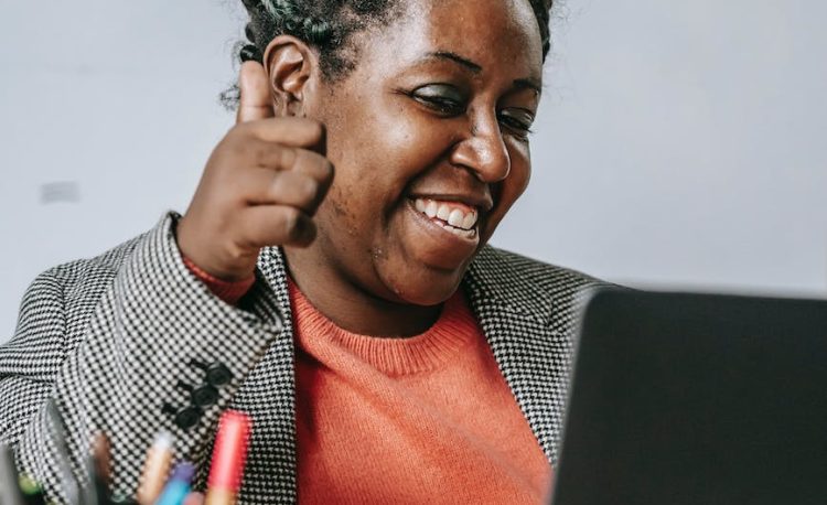 positive black teacher showing thumb up during online test