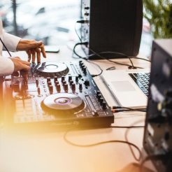 photo of person holding dj controller