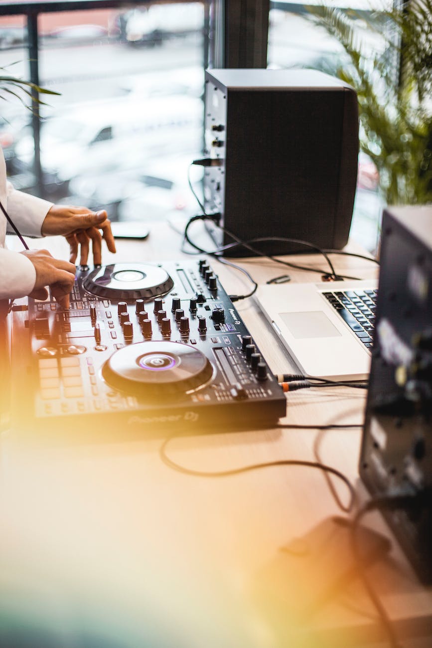 photo of person holding dj controller