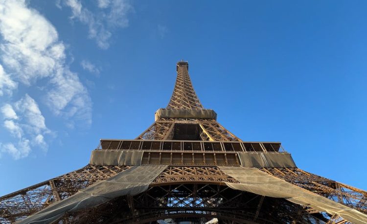 low angle shot of the eiffel tower against blue sky paris france