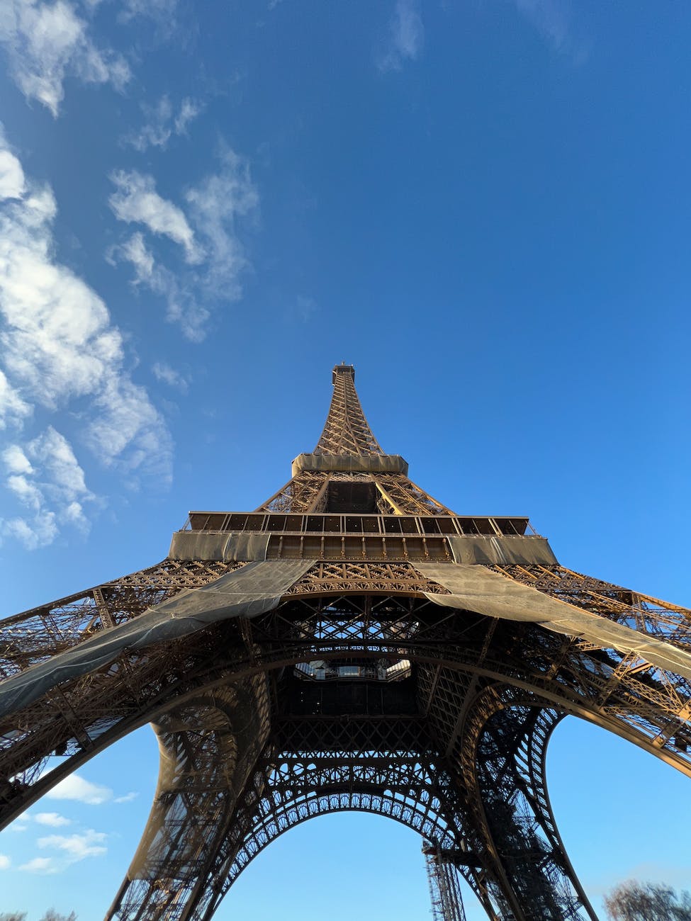 low angle shot of the eiffel tower against blue sky paris france