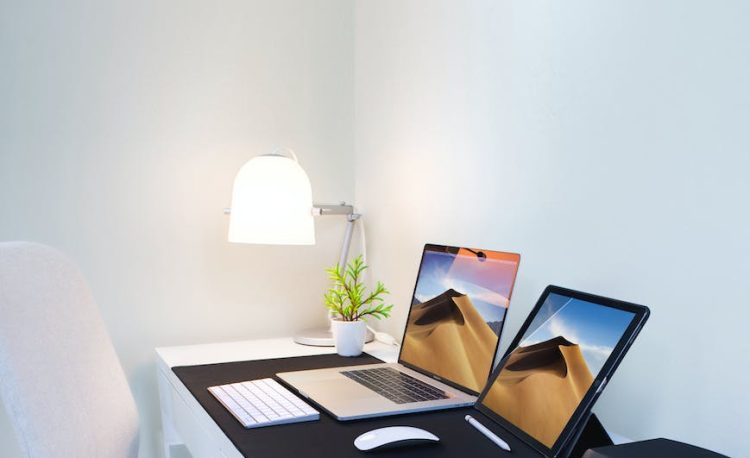 photo of a laptop and a tablet on the table
