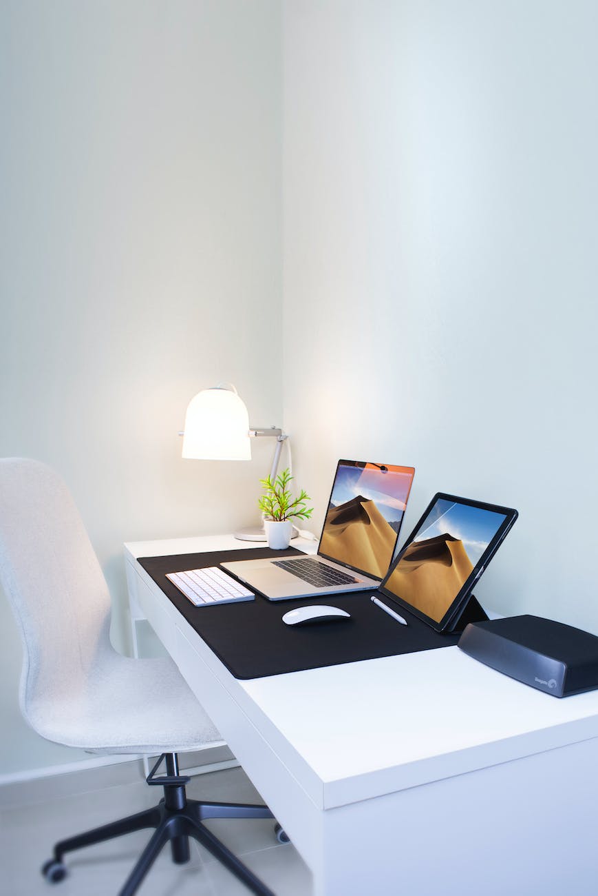 photo of a laptop and a tablet on the table