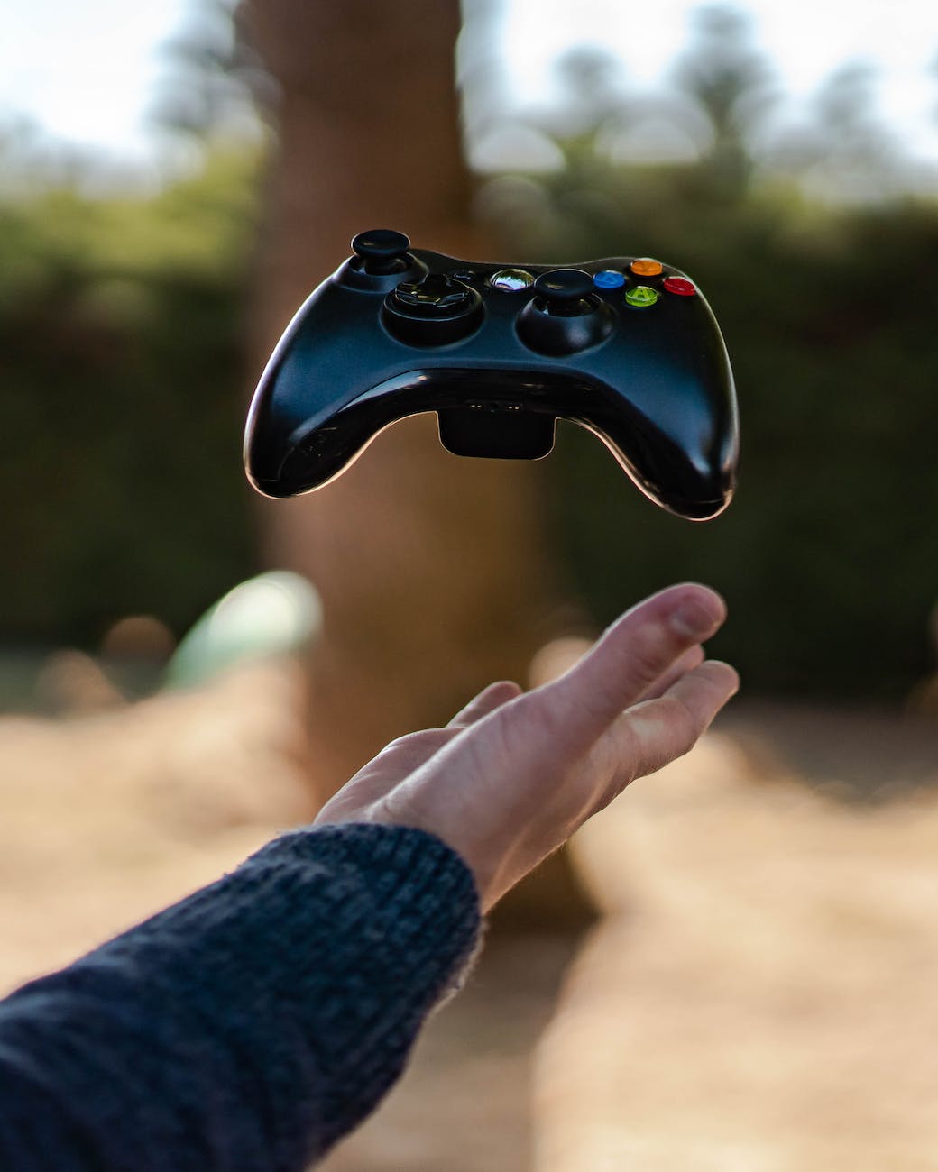 photo of person catching gamepad