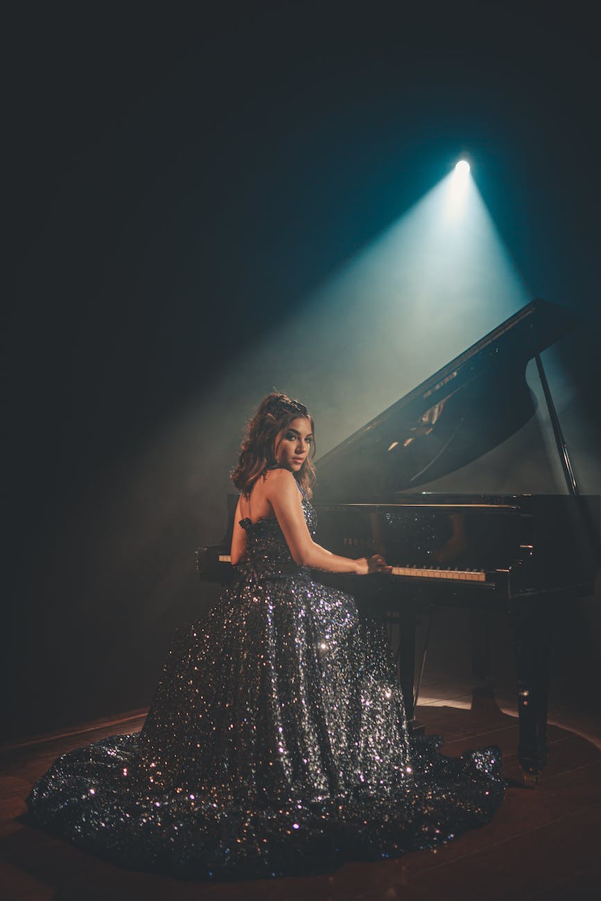 woman sitting near piano