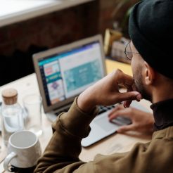 backview of man using laptop