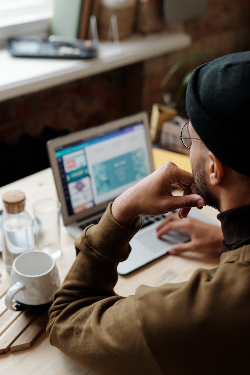 backview of man using laptop