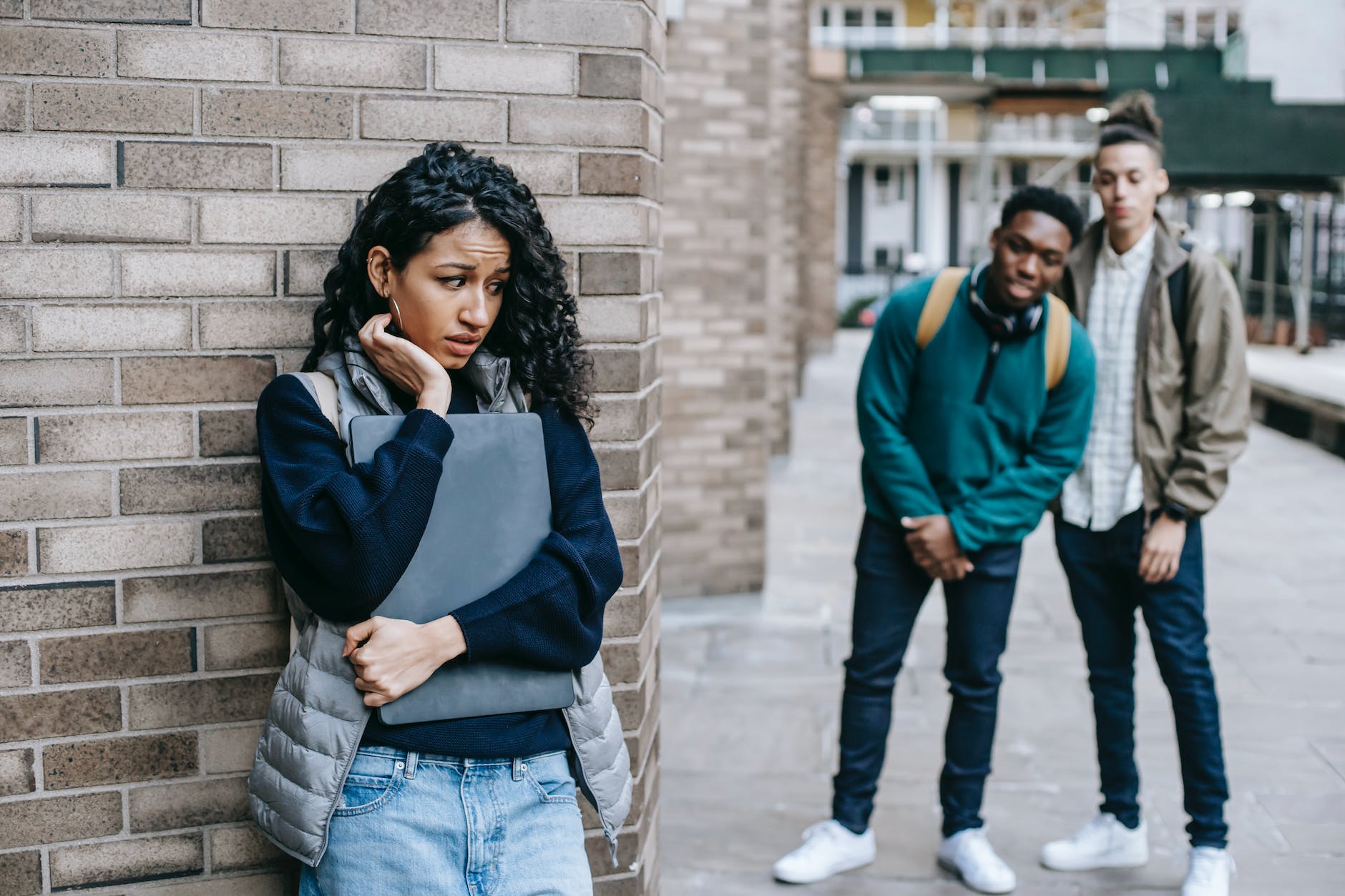 diverse classmates bullying hispanic student in university