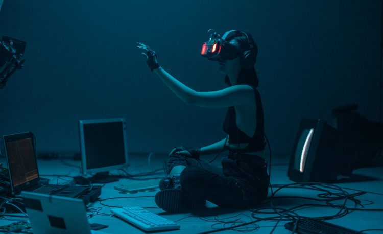 a woman in a tank top using a vr headset