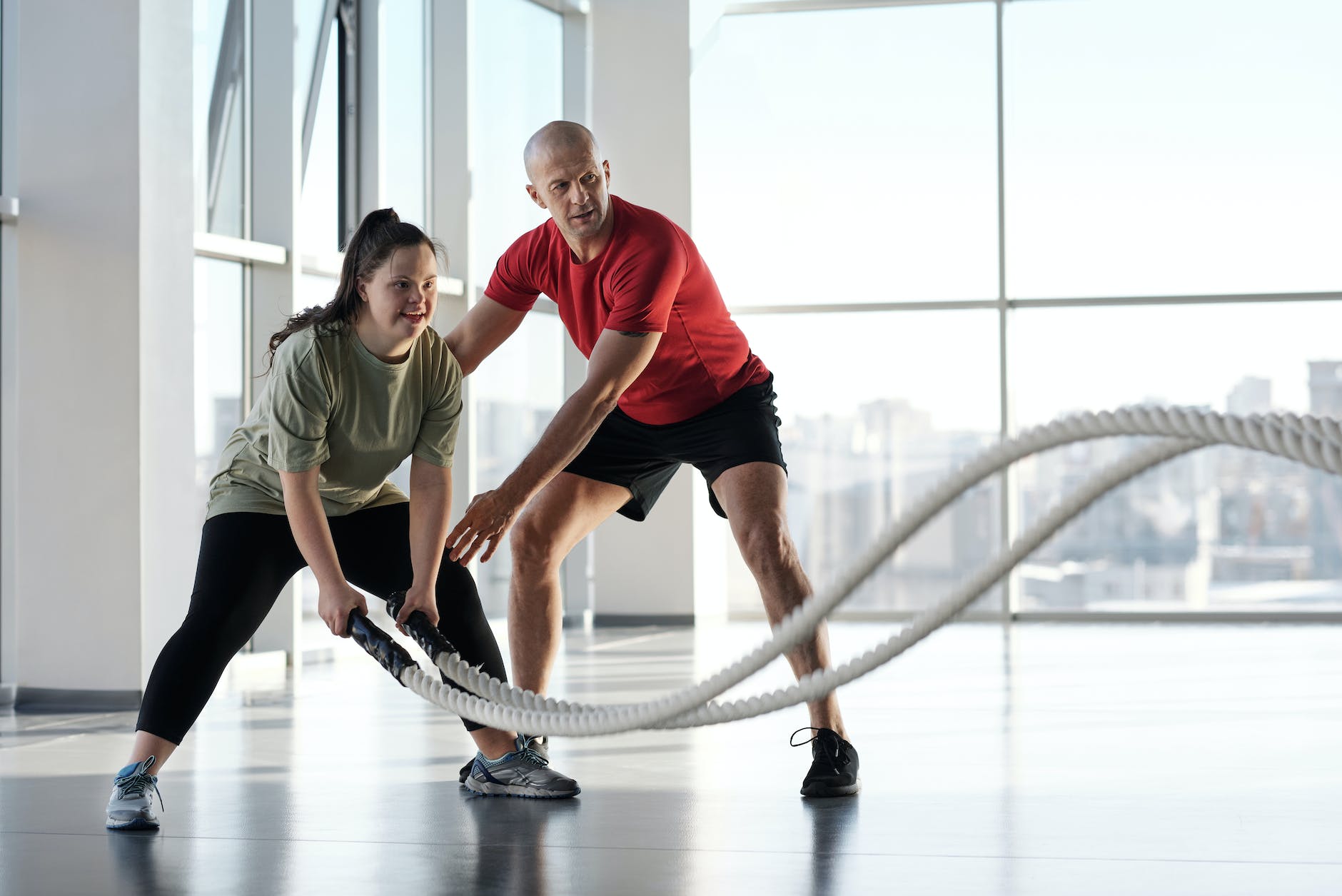 a woman holding ropes beside a trainer