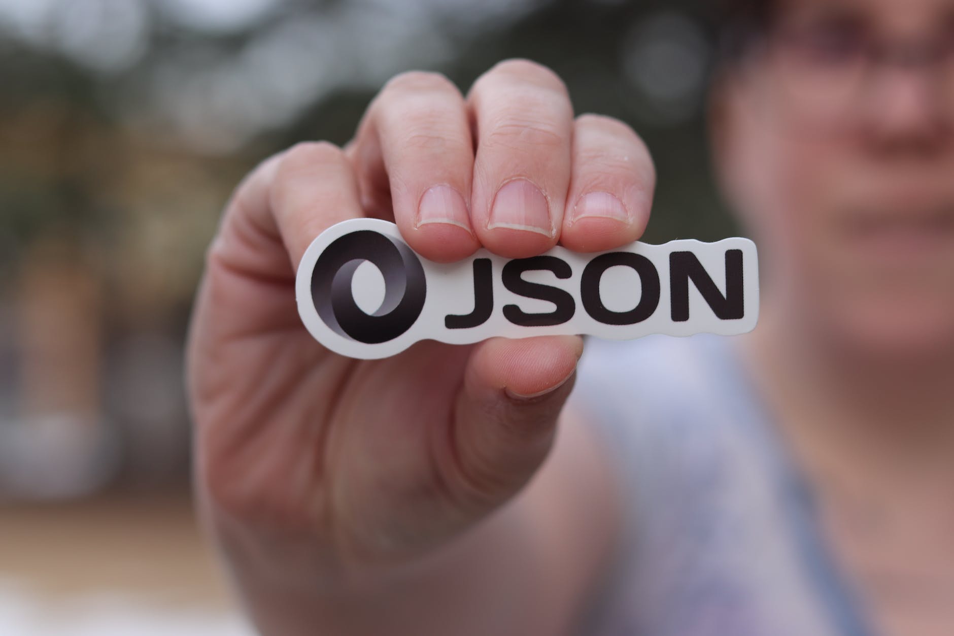 person holding logo of json