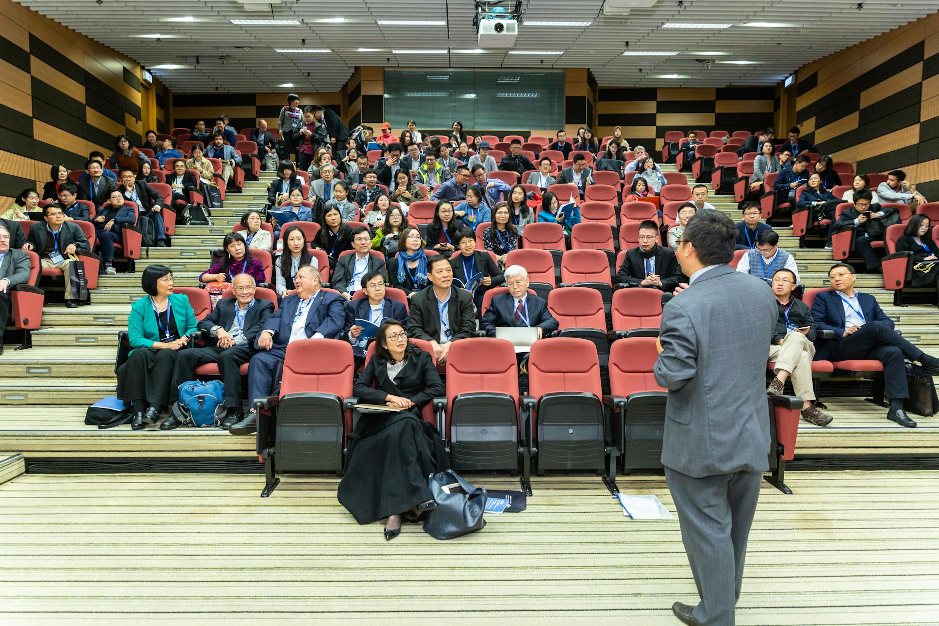 man standing in front of people