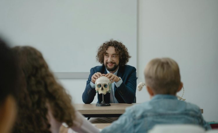 teacher showing his class a human skull