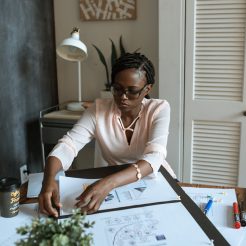 photo of woman working on white paper