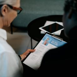 woman holding a clipboard with resume