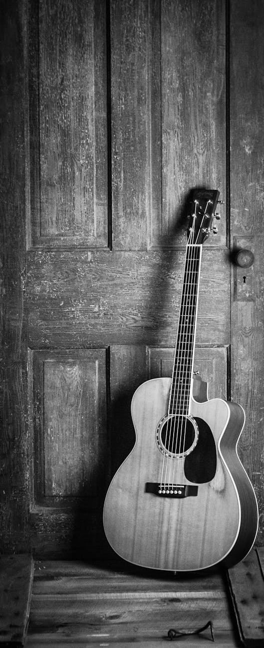 brown and black cut away acoustic guitar