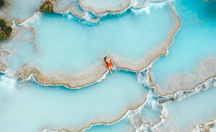 tourist relaxing in the hot springs of tuscany