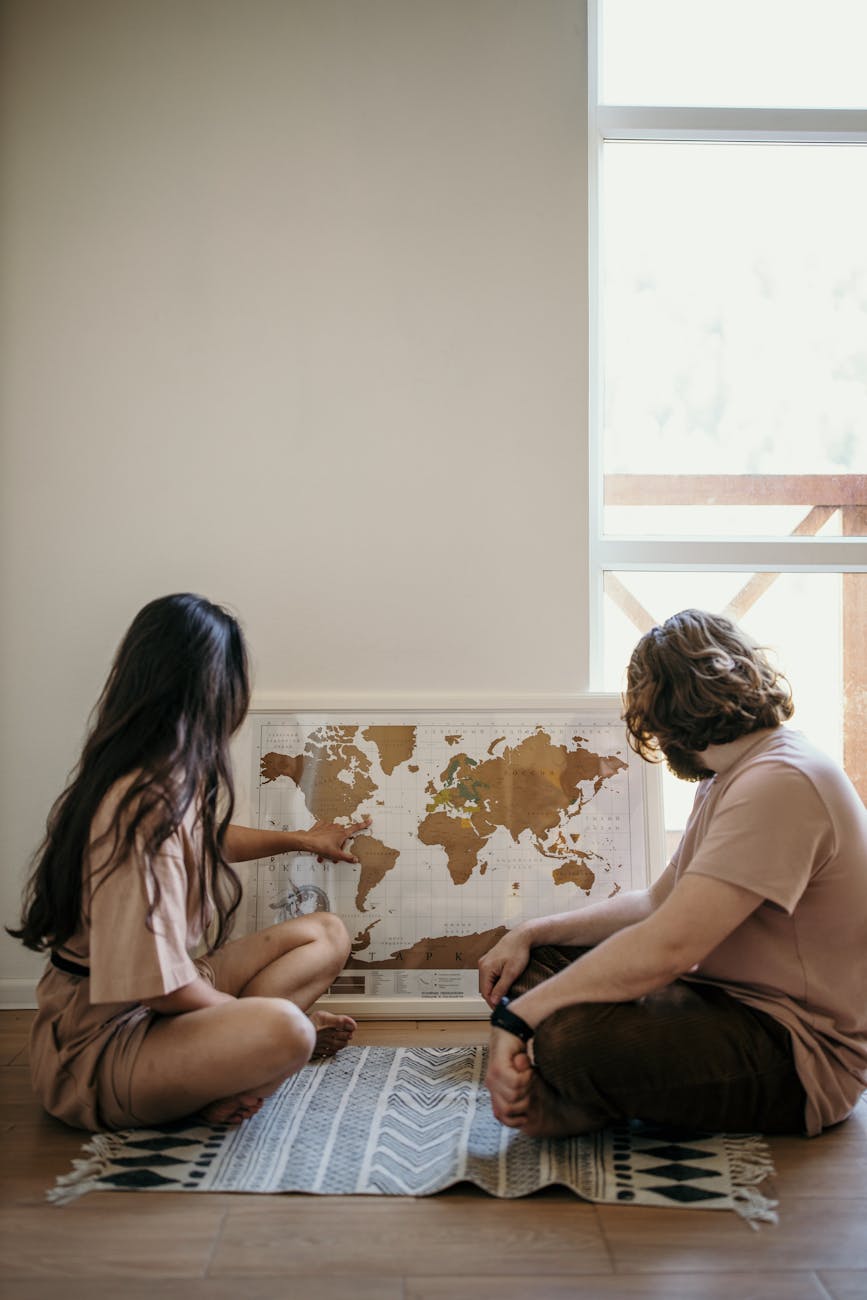 woman in white shirt sitting beside woman in brown shirt