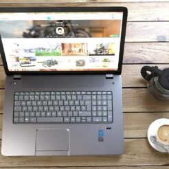 silver laptop next to coffe cup smartphone and glasses