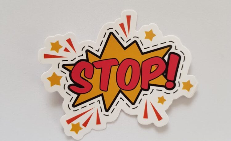 red and yellow stop sticker