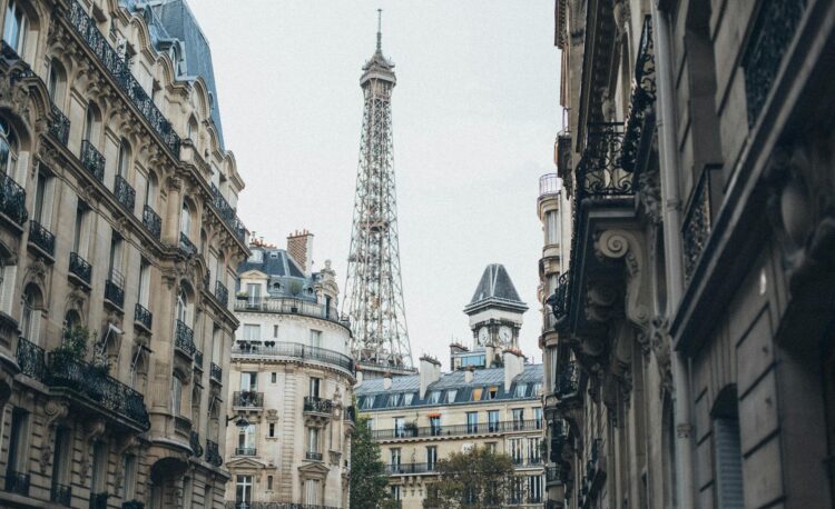 eiffel tower behind buildings