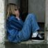 lonely girl sitting on a doorway