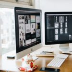 silver imac on top of brown wooden table