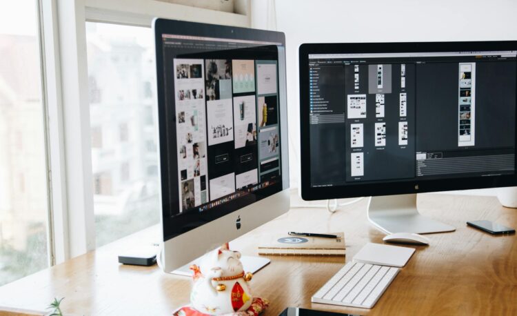 silver imac on top of brown wooden table